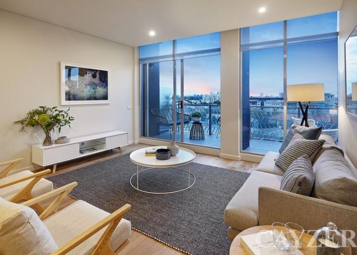 Apartment lounge room with city view after property styling