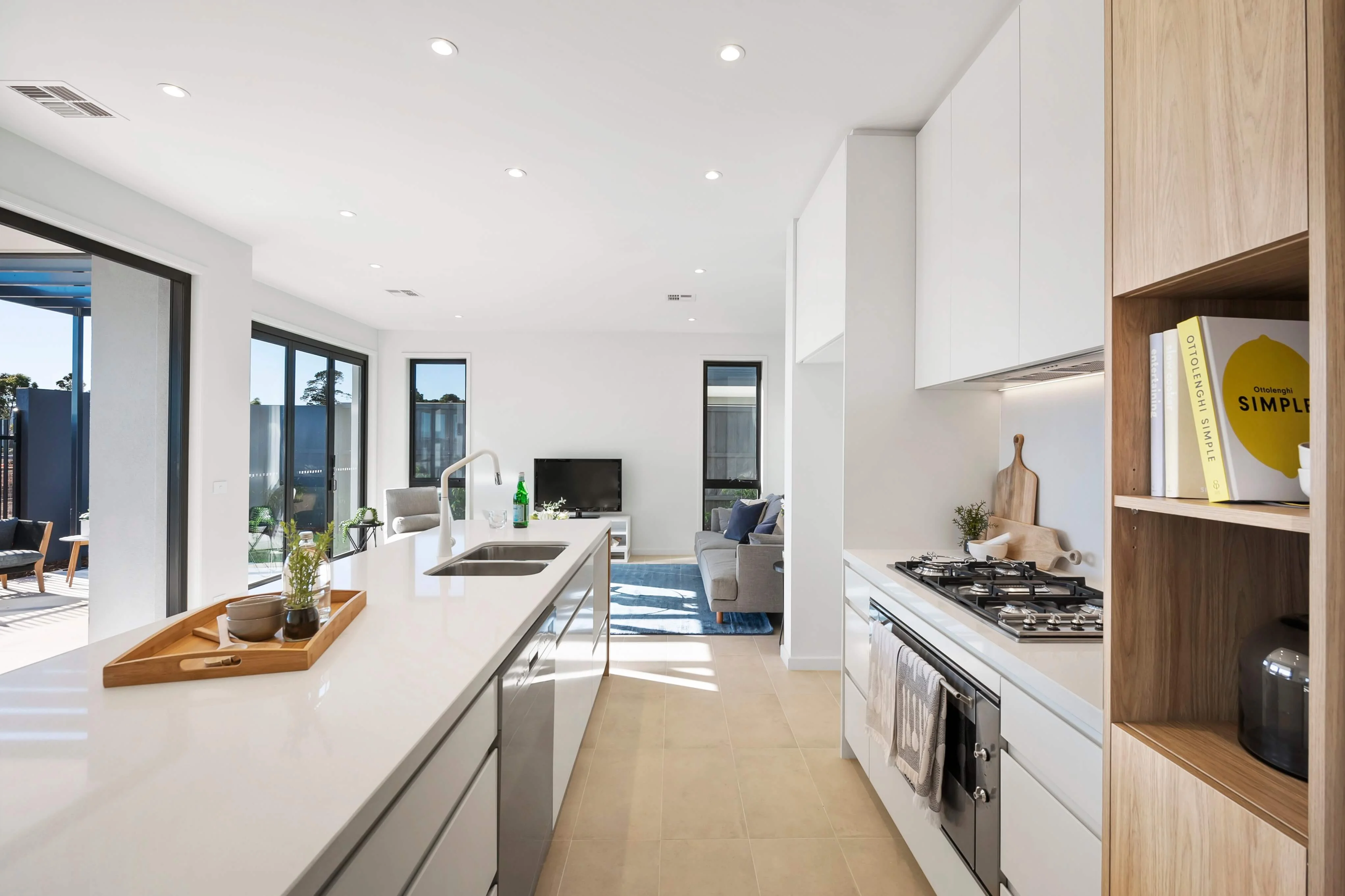 Acacia Display Home Kitchen styled with timber tray, clay bowls, chopping board and cook books