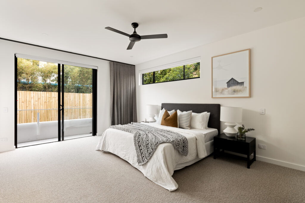 Master Bedroom styled with solid brown and twin striped cushions by Citta design.